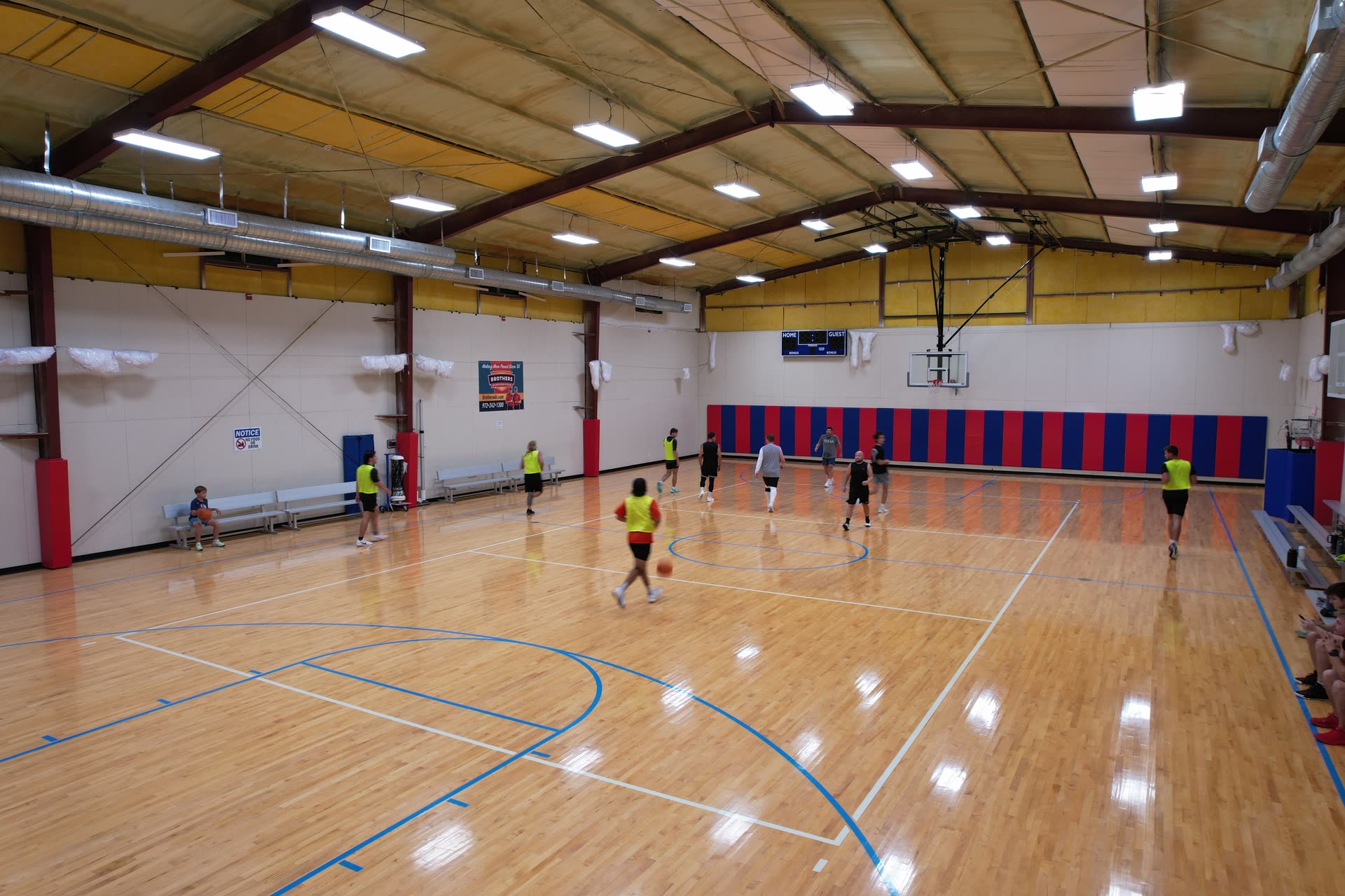 Players running a scrimmage at Hilltop Court
